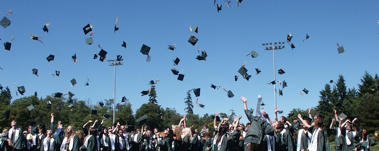 Students celebrating graduation by throwing caps in the air